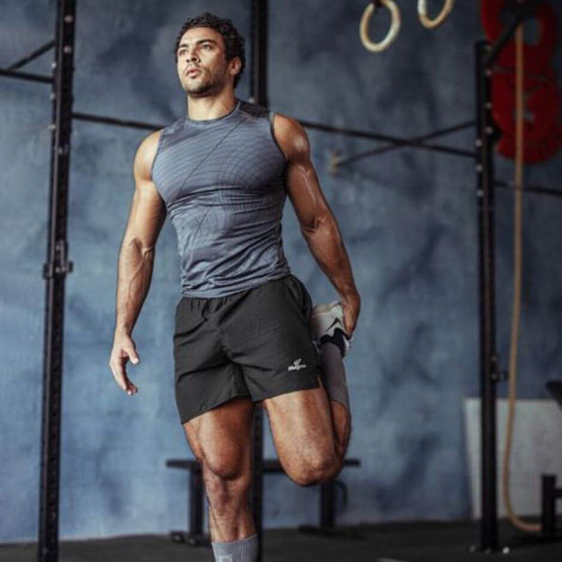 Athletic man stretching in a gym, emphasizing fitness and active lifestyle, preparing for a workout.