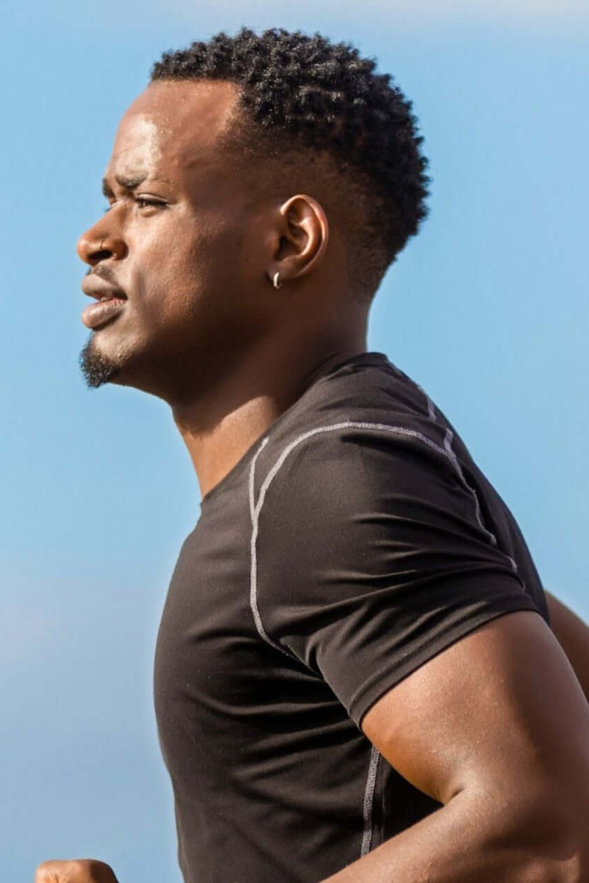 Active man jogging outdoors in sportswear, promoting a healthy and active lifestyle with natural supplements.